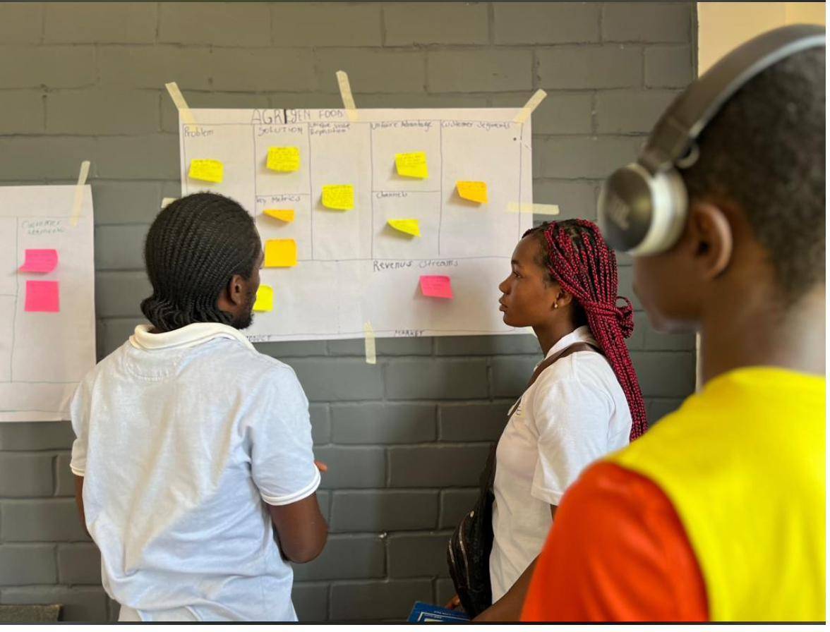 Yinnoh scholars working on a business model canvas in the innovation hub
